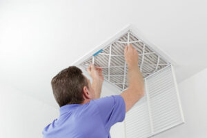 Replacing an air filter to improve indoor air quality.