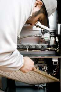 repairman performing furnace maintenance in North Little Rock
